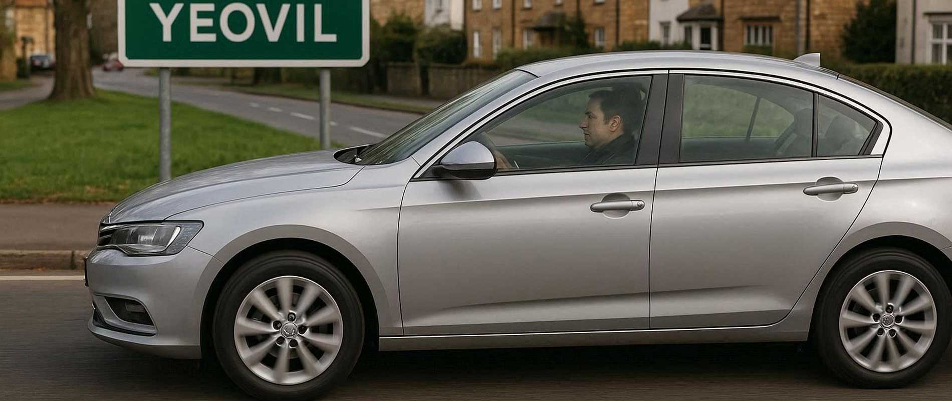 A black SUV passing through a green area in yeovil